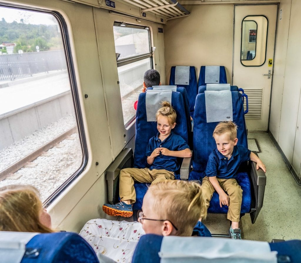 worldschooling- my boys and oldest daughter sitting on the train