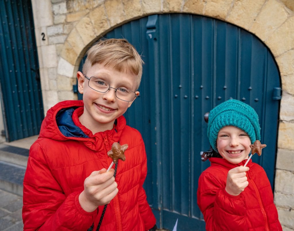 worldschooling- my 2 older boys enjoying Belgium chocolate on a stick