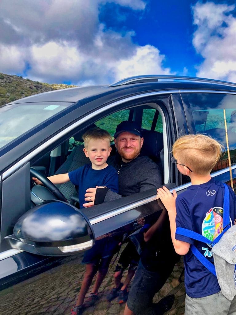 my husband and 2 of my sons sitting in the car