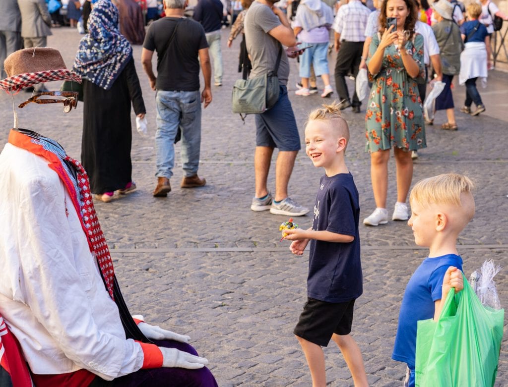 traveling in rome- my sons enjoying watching some street performers