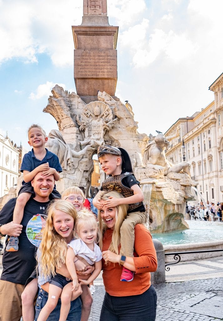 traveling in rome- a silly family picture in front of a beautiful Roman fountain
