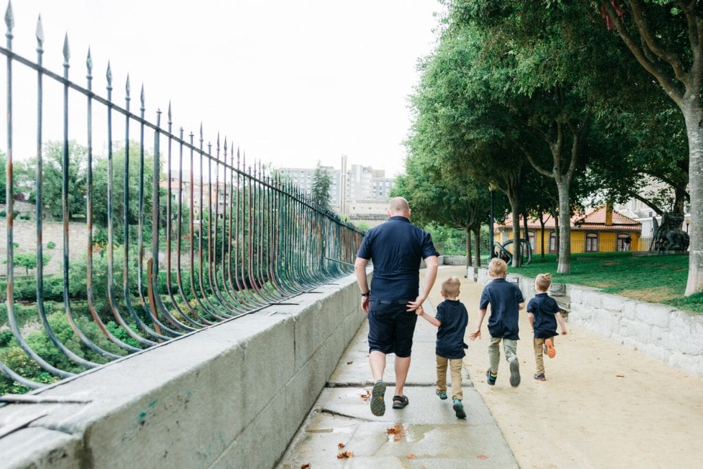 family travel- my husband and sons walking on the sidewalk