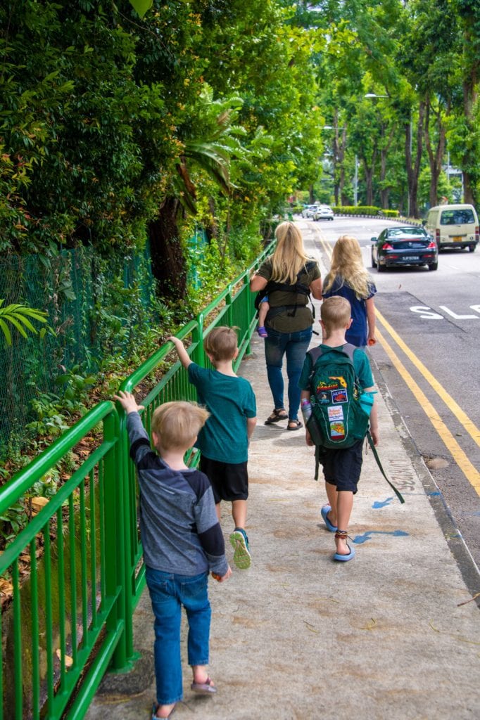 My kids and I walking down the sidewalk in Singapore 