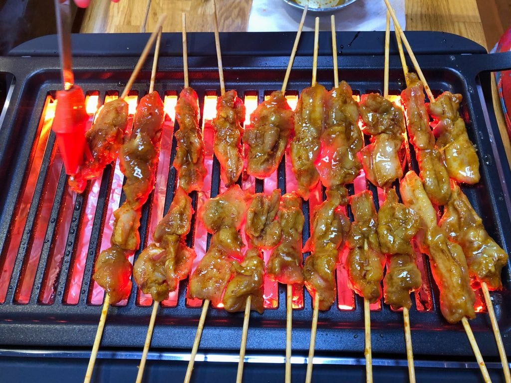 The chicken satay on the grill 