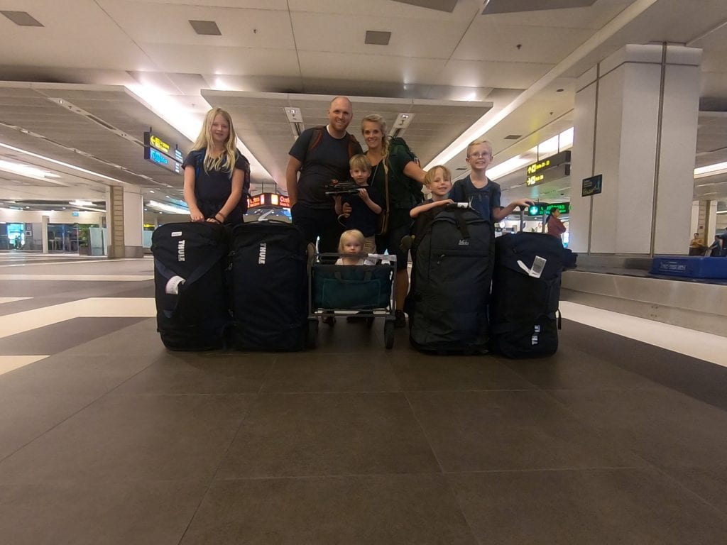 Family picture in the airport with all of our luggage