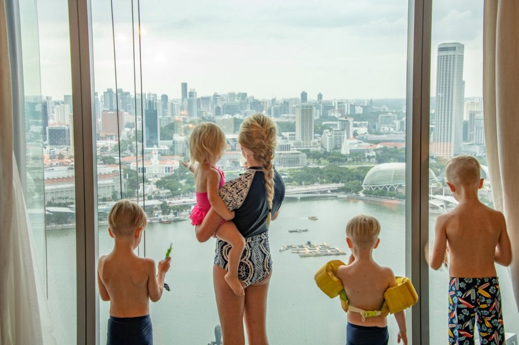 singapore travel guide- my kids enjoying the view of downtown from our hotel window