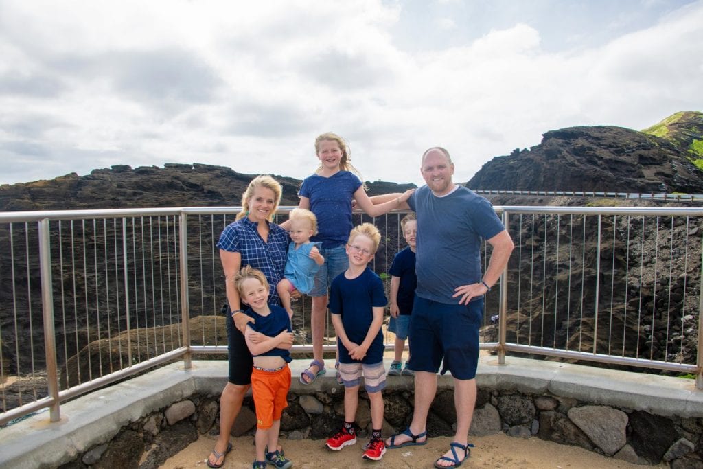travel vaccinations- a family picture with a beautiful rocky view