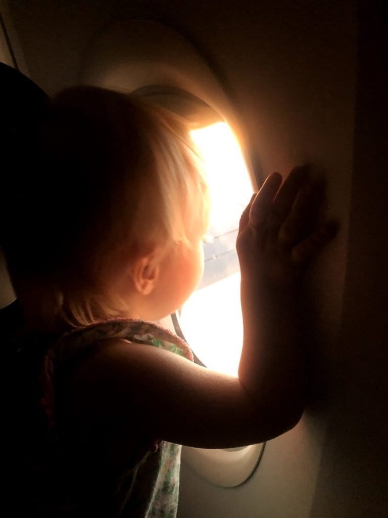 My kid looking out of the window on the airplane 