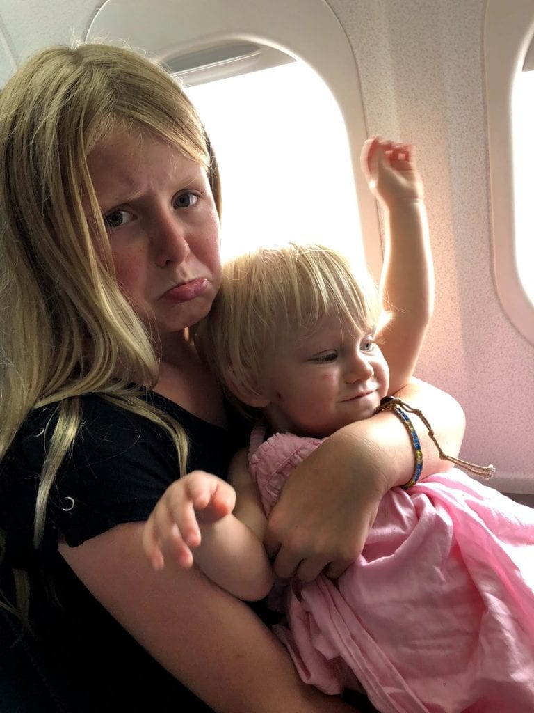 Tips for flying with kids- 2 of my kids on the airplane