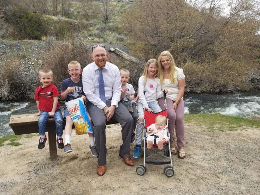 Family picture in front of a small stream 