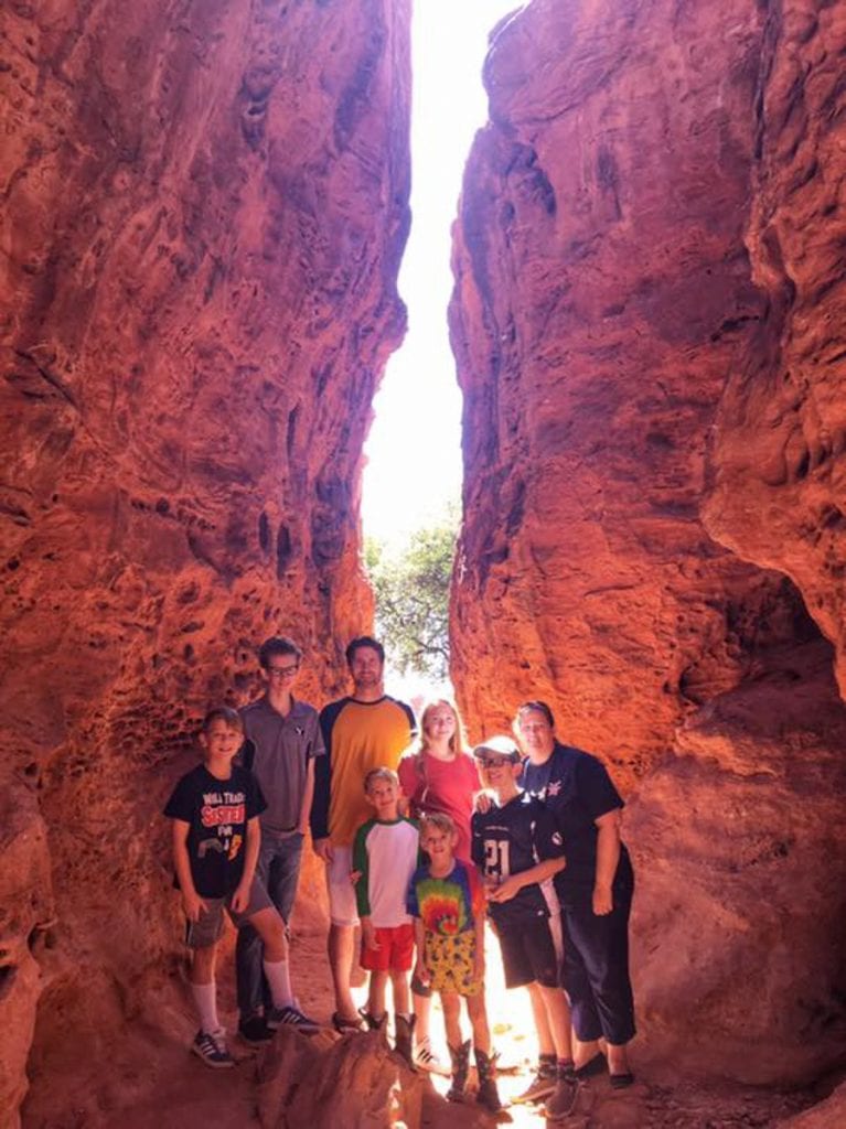 The Flory family in between two large red colored rock formations