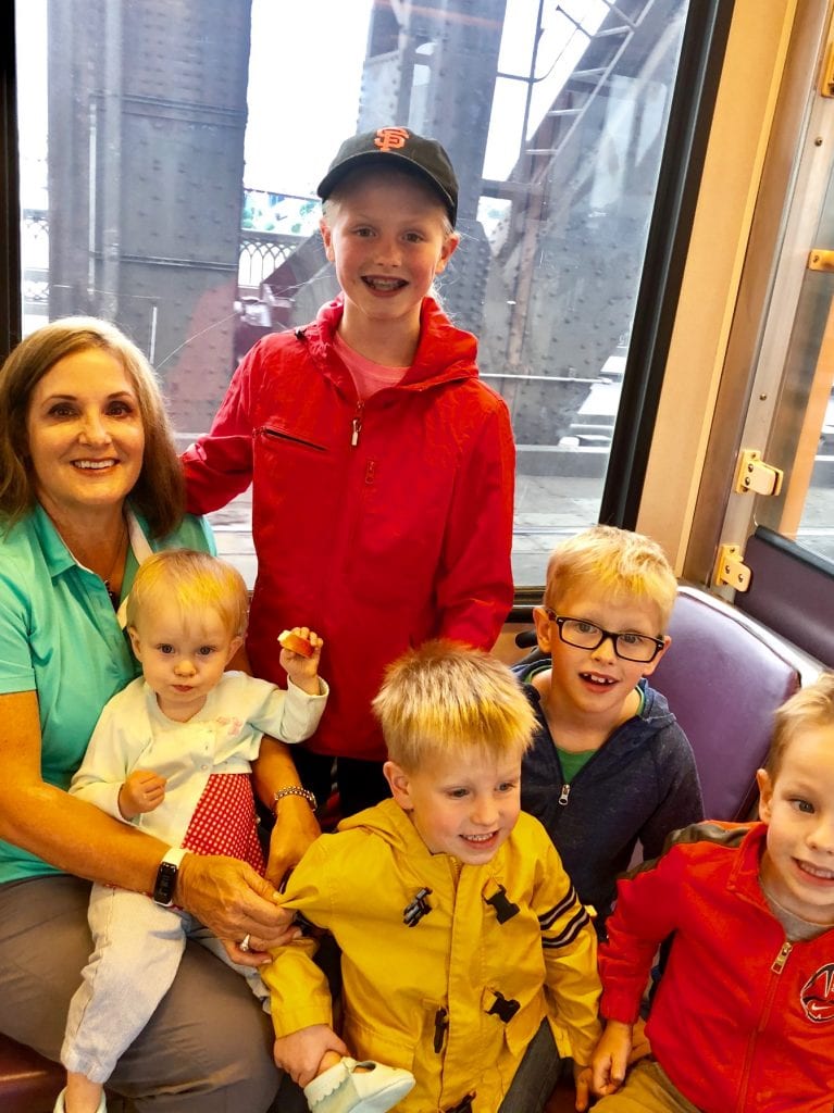 All of the kids and grandma sitting in the street car 