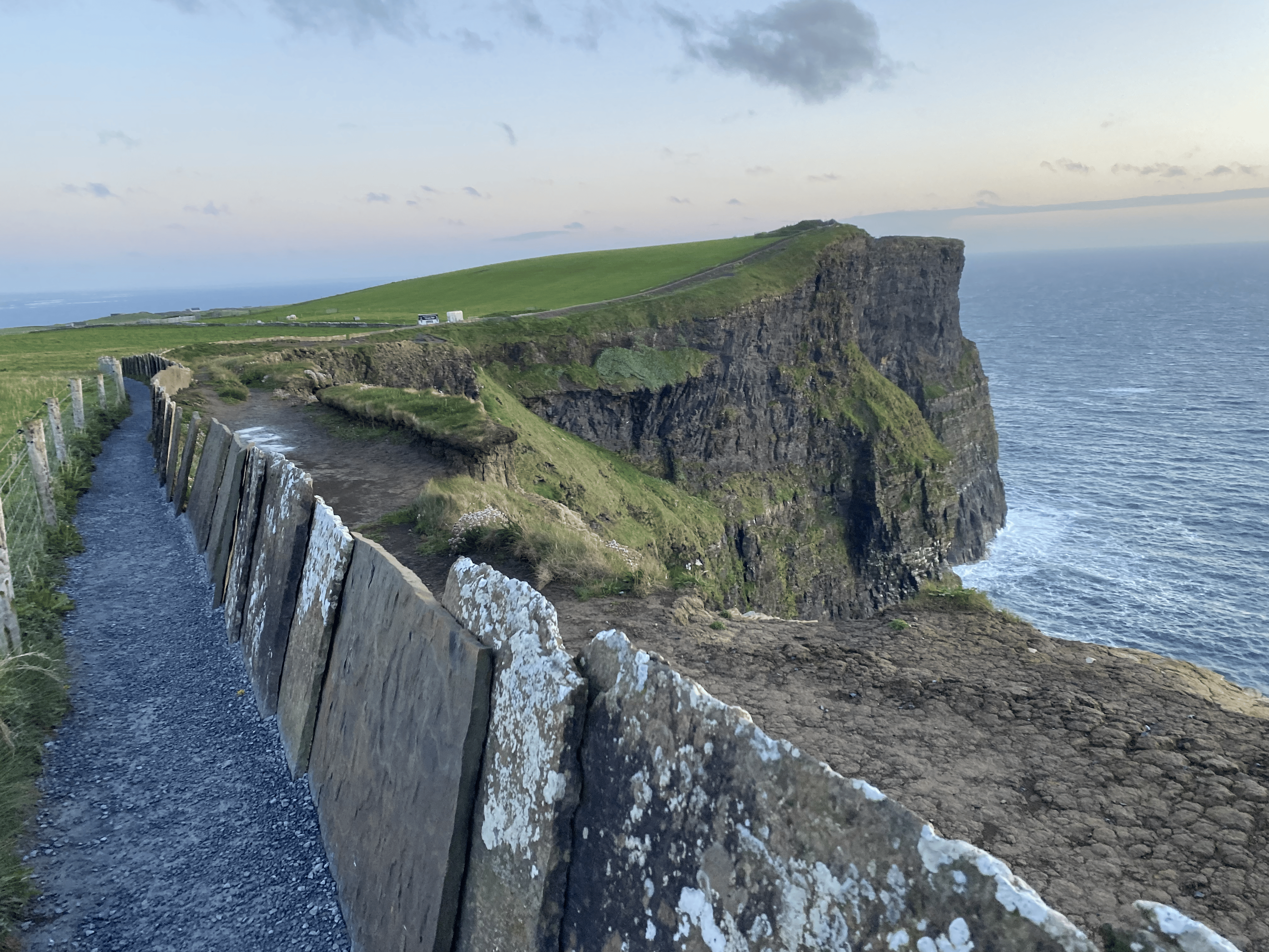 Some of the trails have bars you can hold onto, as you can see they are close to the edge of the Cliffs of Moher with kids.
