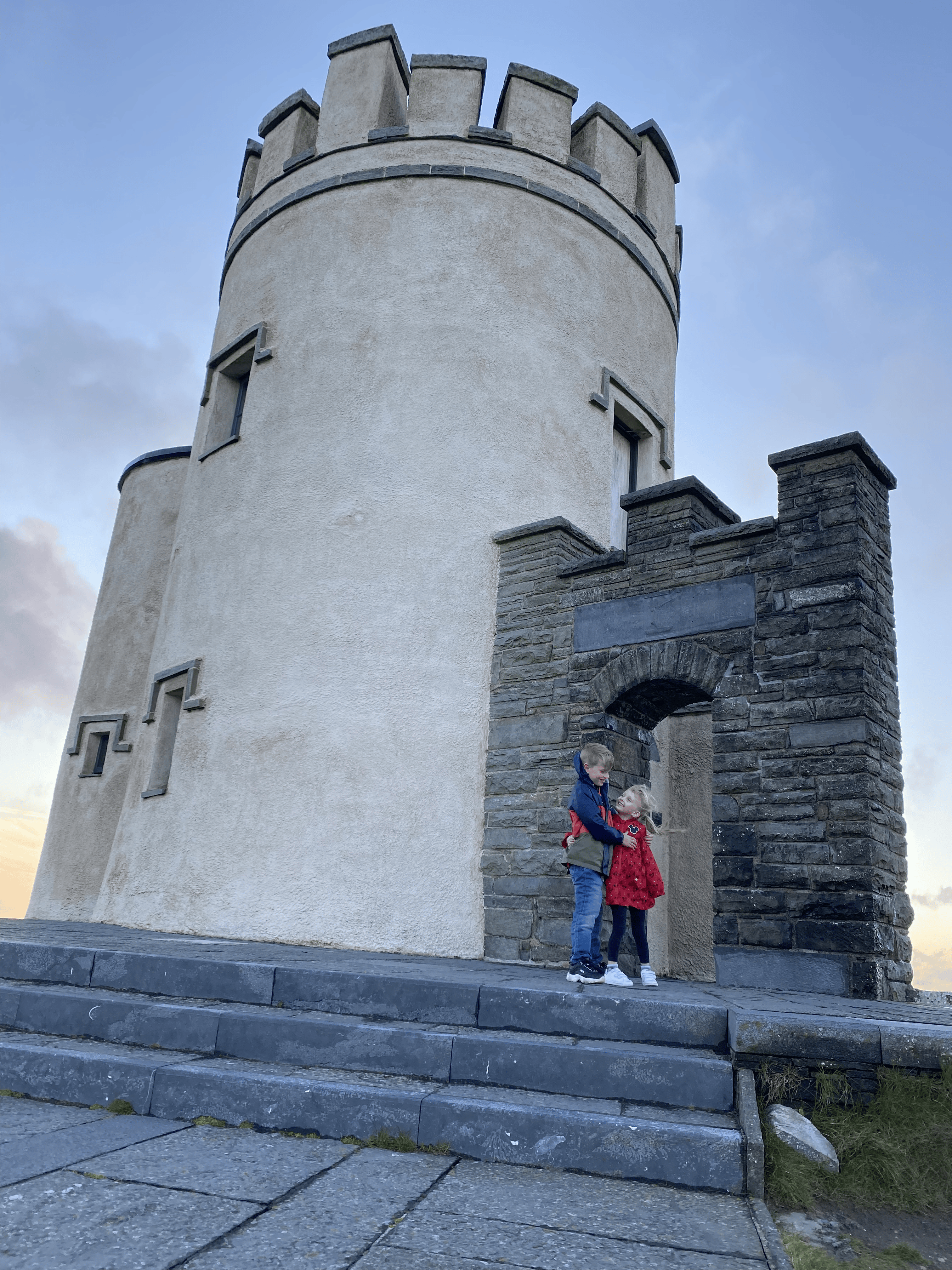 Cliffs of Moher with kids. The castle at the tallest part of the cliffs.
