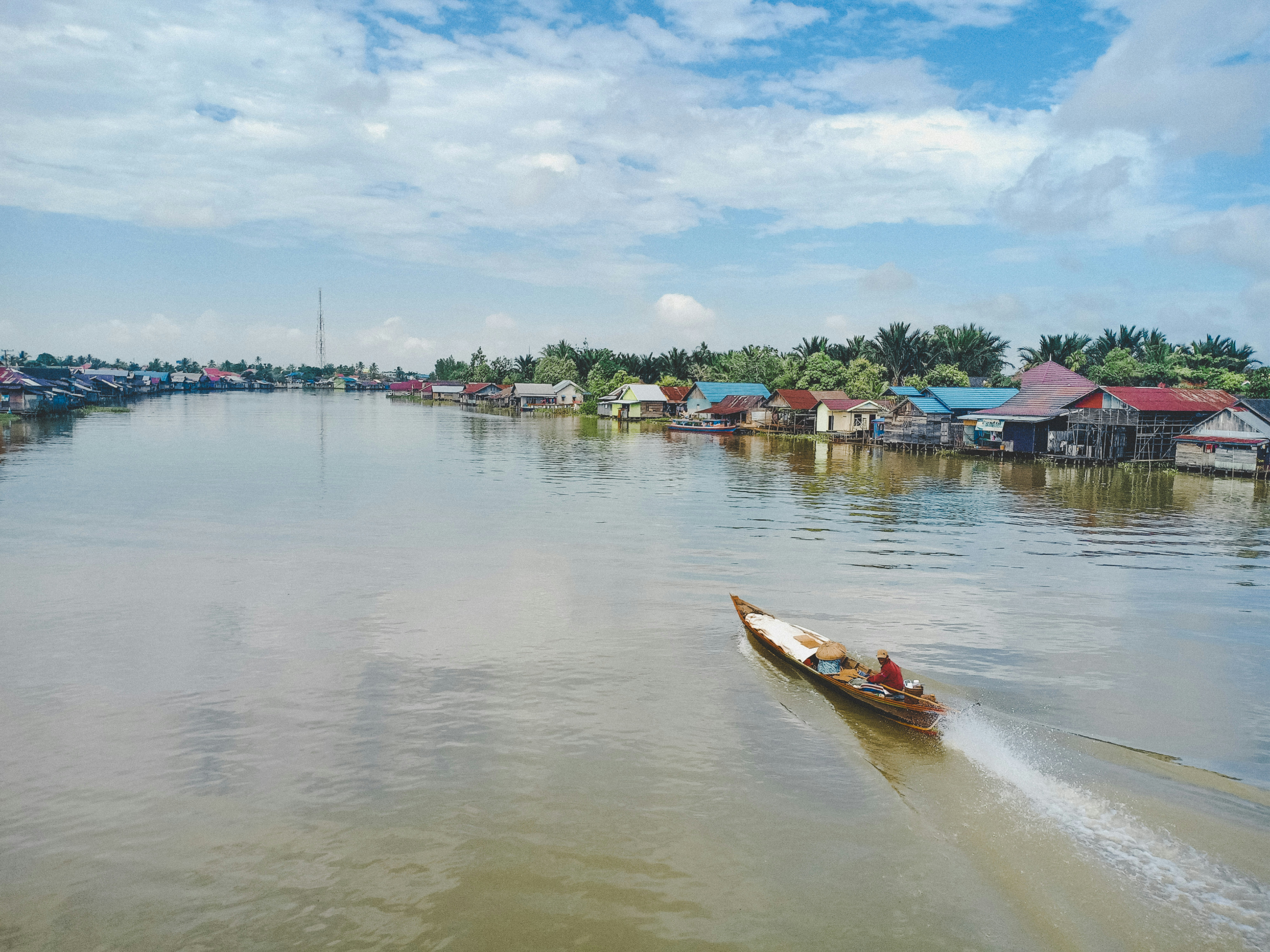Gliding through river life, where colorful stilt houses meet calm waters and everyday journeys unfoGliding through river life, where colorful stilt houses meet calm waters and everyday journeys unfold.  Source: Unsplash.ld.  Source: Unsplash.
