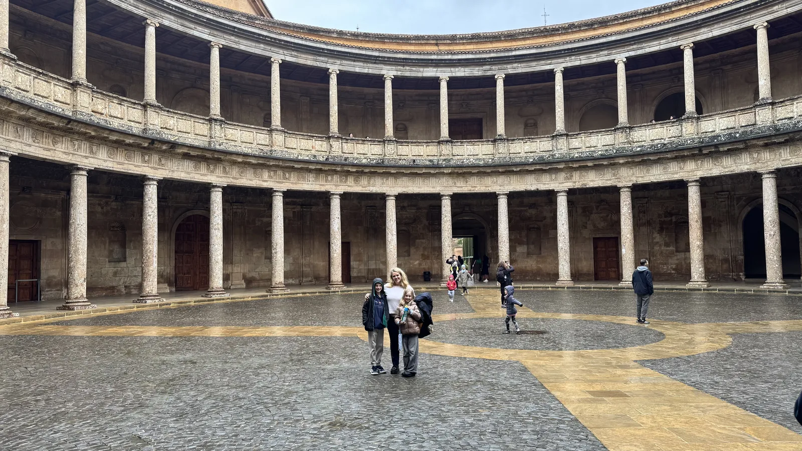 Circular stone courtyard surrounded by two levels of columned galleries.