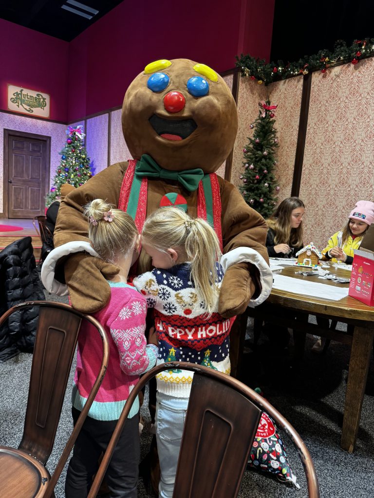 Two girls hugging gingerbread man